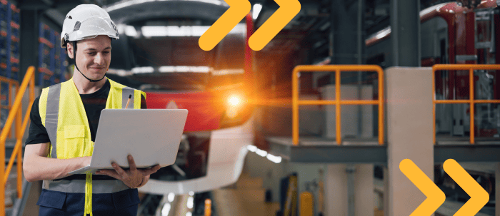 Hombre ingeniero industrial con una laptop en una fábrica